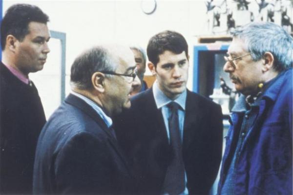 The son (second right) watches as the boss talks to his father on the shop floor.