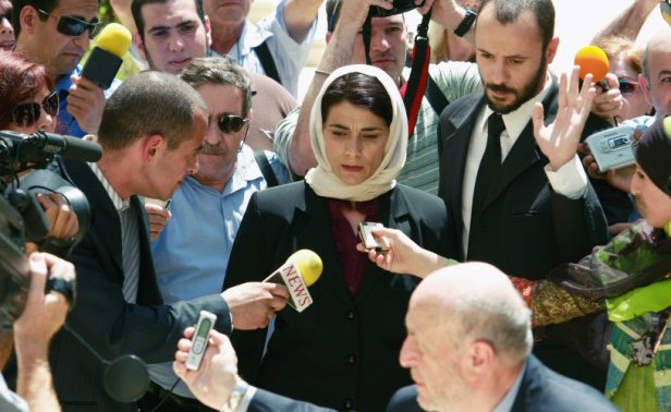 Salma and her lawyer are mobbed by the media outside the Supreme Court.