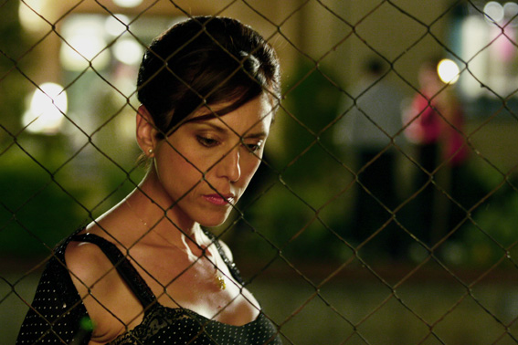 Rona Lipaz-Michael plays Mira, here pensive on the 'other side' of the wire which 'protects' her from the lemon grove.