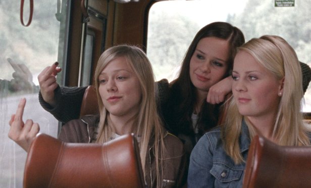 from the left: Alma (Helene Bergsholm), Sara (Malin Bjorhovde) and Ingrid (Beate Stofring) give the finger to the small town's nameboard.