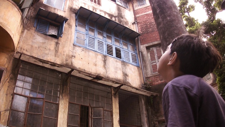 Sarthak's son looks up at the old house