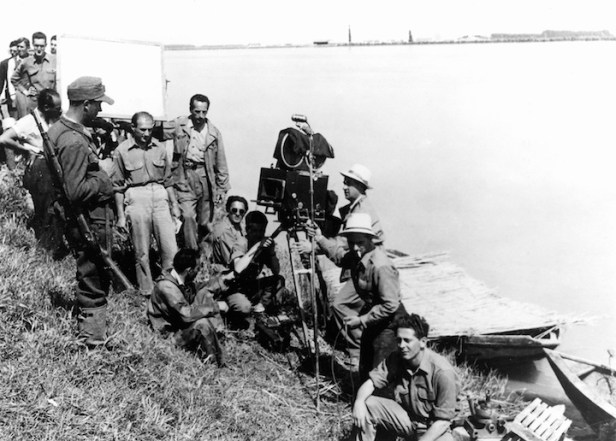 Roberto Rossellini (standing beneath the lighting reflector) on location in the Po valley for Paisa.