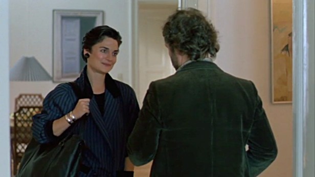 . . . and with the American record label representative (played by Cristine Rose) in an apartment in West Berlin