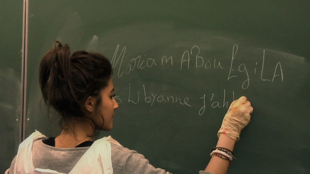 Mariam, a Libyan girl who has been living in Egypt attempts to write in French at the start of SCHOOL OF BABEL. photo courtesy New Wave Films