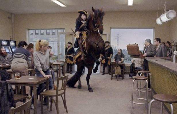 A rider comes to announce that the King wishes to use the toilet in the bar – of corse it is occupied!