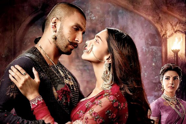 Mastani (Deepika Padukone) and Bajirao (Ranveer Singh) in the foreground, Kashibai (Proyinka Chopra) looks on.