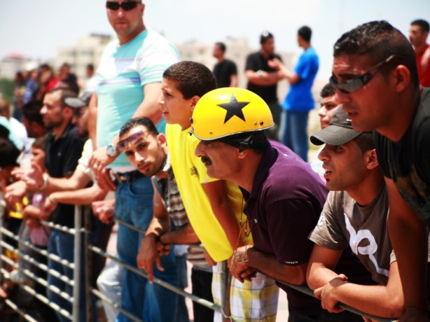 Marah's father and brothers watch her race. Photo by Amber Fares.