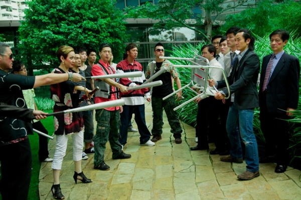'Swallow' (Ekin Cheng) with the chair faces his mother and her thugs who seek to persuade him to stand for election as Triad Chairman 