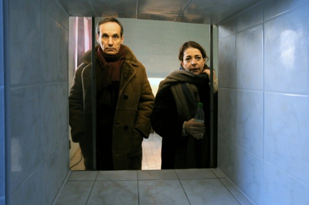 One of the more expressive shots during the adoption process – the couple are watching a doctor with a child through a window.