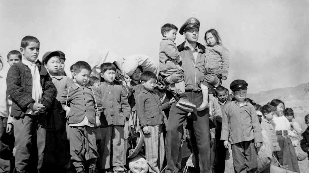 Production still of Rock Hudson with Korean orphans flown to the US for the shoot.