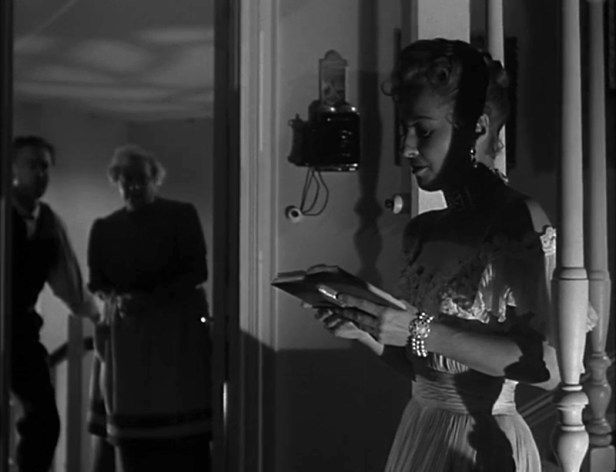 Low key lighting as Naomi reads a poem at the after show party.