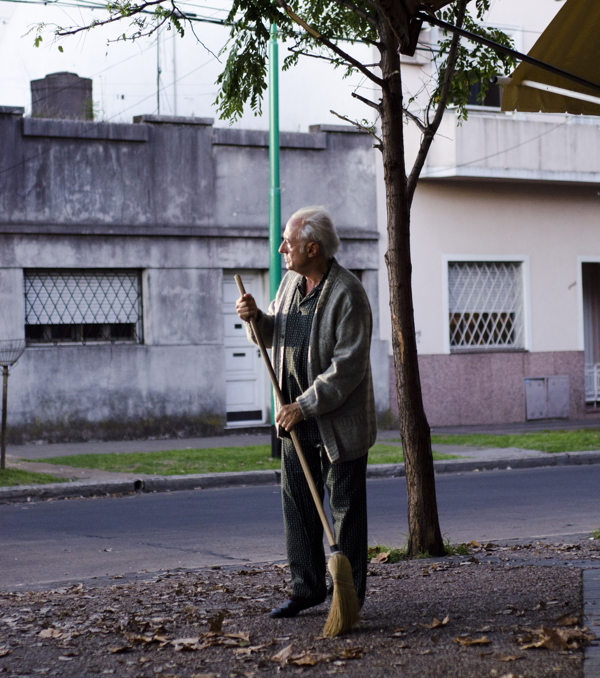 The 'normalcy' of sweeping the pavement in the morning.