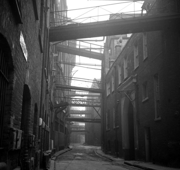 The noirish mise en scène readily available on location among the warehouses of the Port of London